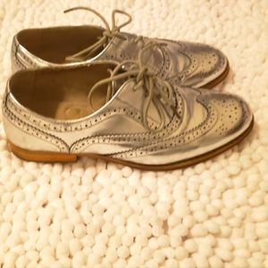 Gently used silver laceup loafers can be dressed up or down.